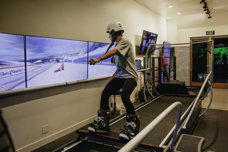 Snowboarder training on the SkyTechSport snowboard simulator at Home Mountain in Los Angeles